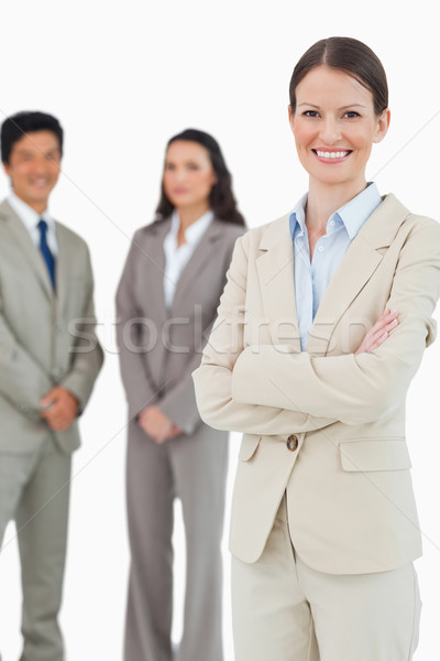 Smiling tradeswoman with employees behind her against a white background Stock photo © wavebreak_media