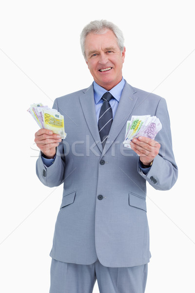 Smiling mature tradesman with cash in his hands against a white background Stock photo © wavebreak_media