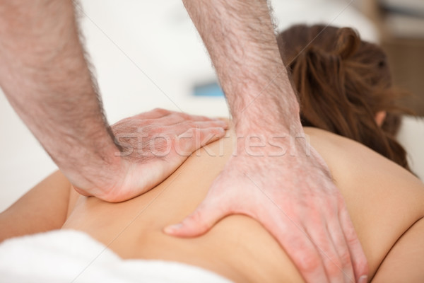 Woman lying on the belly while being massaging with two hands of doctor indoors Stock photo © wavebreak_media