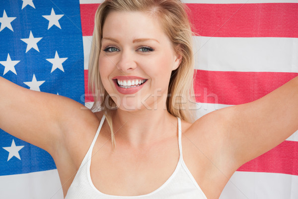 Cheerful woman holding the American flag in a studio Stock photo © wavebreak_media
