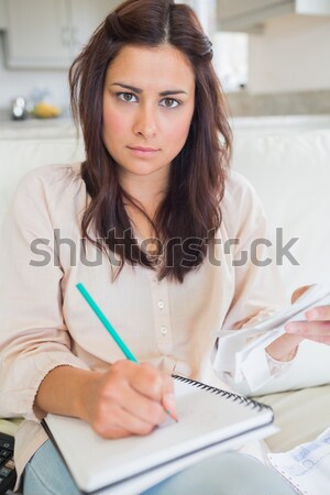 Young woman calculating finances on sofa Stock photo © wavebreak_media