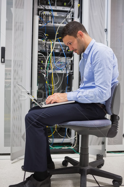 Man on his laptop beside servers in data center Stock photo © wavebreak_media