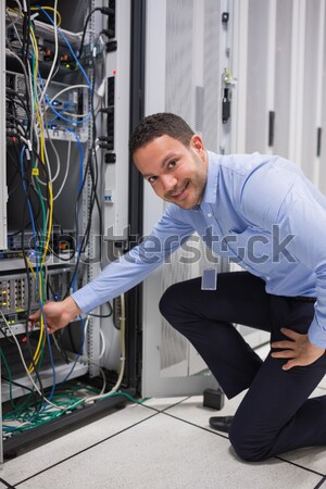 Technician plugging in cables and using tablet pc in data center Stock photo © wavebreak_media