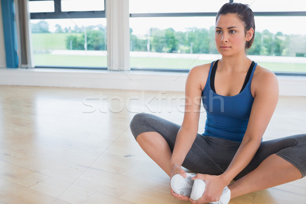 Woman doing bound angle yoga pose in fitness studio Stock photo © wavebreak_media