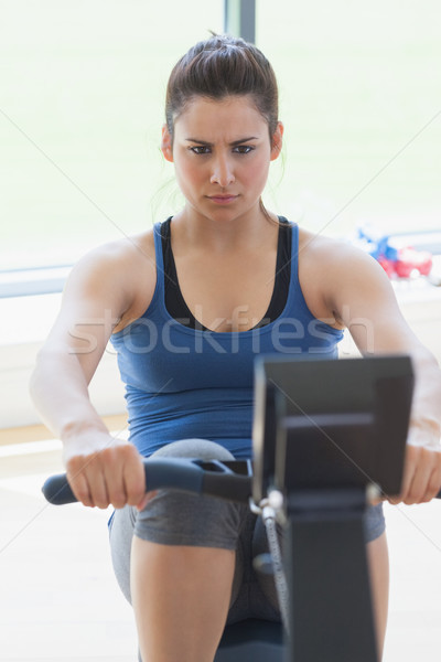 Focused woman at the rowing machine in the gym Stock photo © wavebreak_media