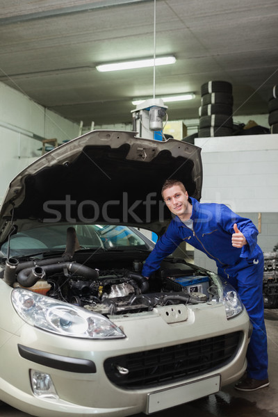 Mechanic by car giving thumbs up gesture Stock photo © wavebreak_media