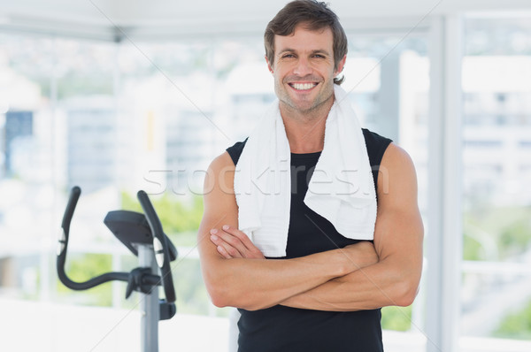 Smiling man standing with arms crossed at spinning class in brig Stock photo © wavebreak_media