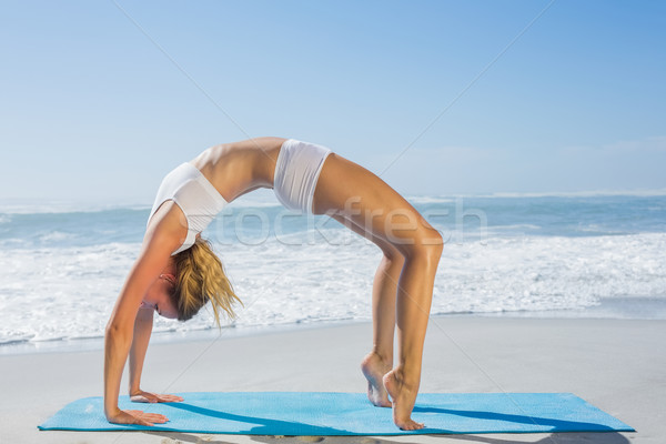 Stock photo: Gorgeous fit blonde in crab pose on the beach