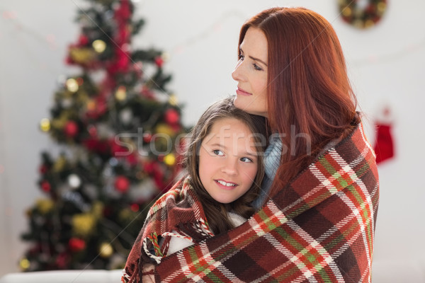 Stock photo: Festive mother and daughter wrapped in blanket