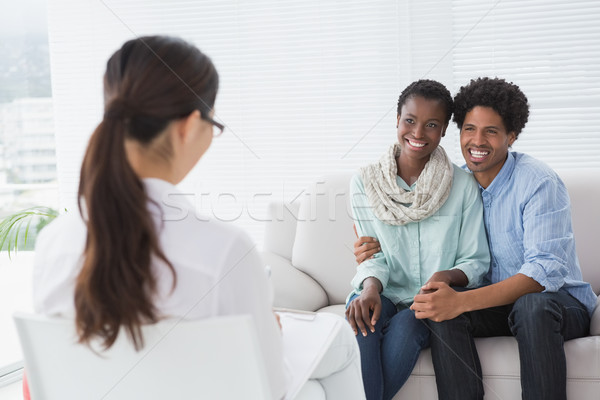 Reconciled couple smiling at their therapist Stock photo © wavebreak_media