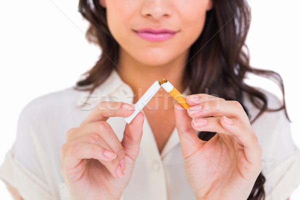 Pretty brunette breaking a cigarette Stock photo © wavebreak_media