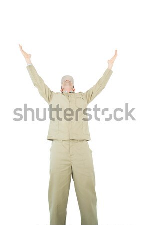Excited delivery man with arms raised looking up Stock photo © wavebreak_media