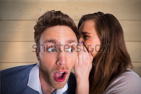 Woman whispering secret into friends ear Stock photo © wavebreak_media
