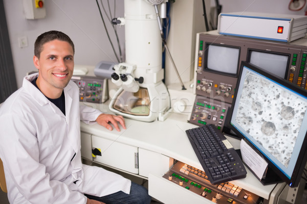 Biochemistry student using large microscope and computer Stock photo © wavebreak_media
