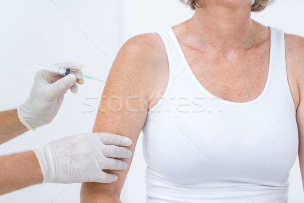 Doctor doing an injection to his patient  Stock photo © wavebreak_media