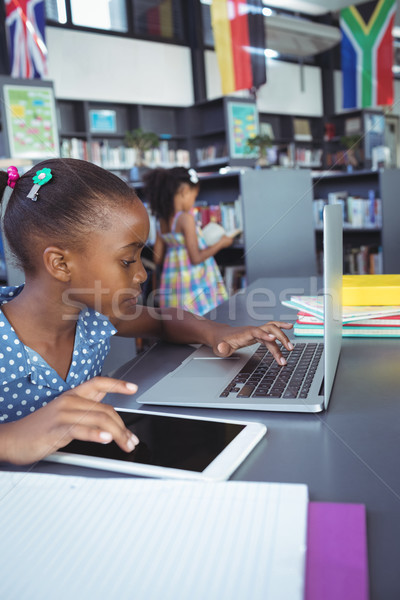 Lány digitális tabletta laptop könyvtár ül Stock fotó © wavebreak_media