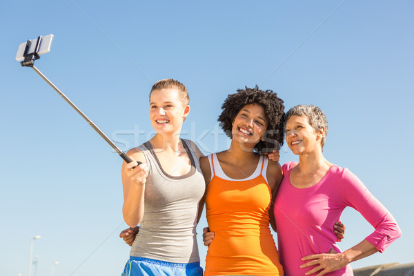 Smiling sporty women taking selfies with selfiestick  Stock photo © wavebreak_media