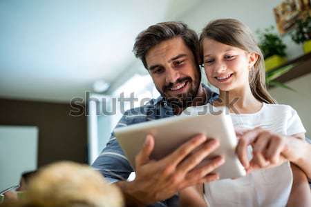 Portrait of happy couple using digital tablet on bed Stock photo © wavebreak_media