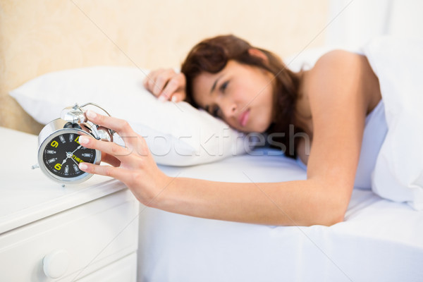 Sleeping woman stopping her alarm Stock photo © wavebreak_media