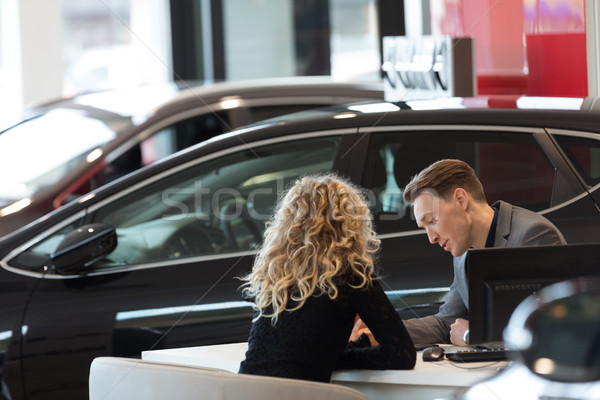 Car salesperson discussing with customer in showroom Stock photo © wavebreak_media