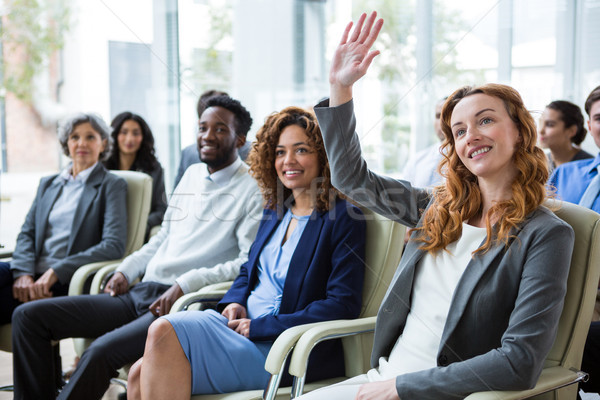 Businesswoman raising hand during meeting Stock photo © wavebreak_media