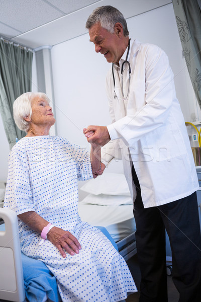 Doctor consoling senior patient in ward Stock photo © wavebreak_media