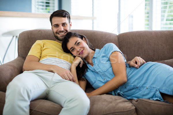 Portrait of smiling couple relaxing in the living room Stock photo © wavebreak_media