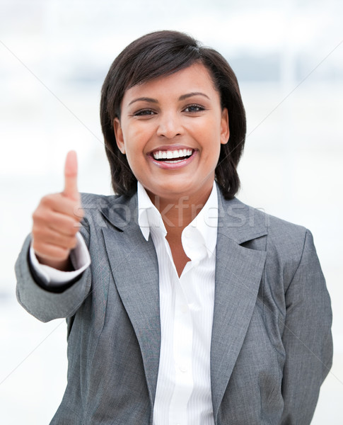 Portrait of a fortunate business woman with a thumb up Stock photo © wavebreak_media