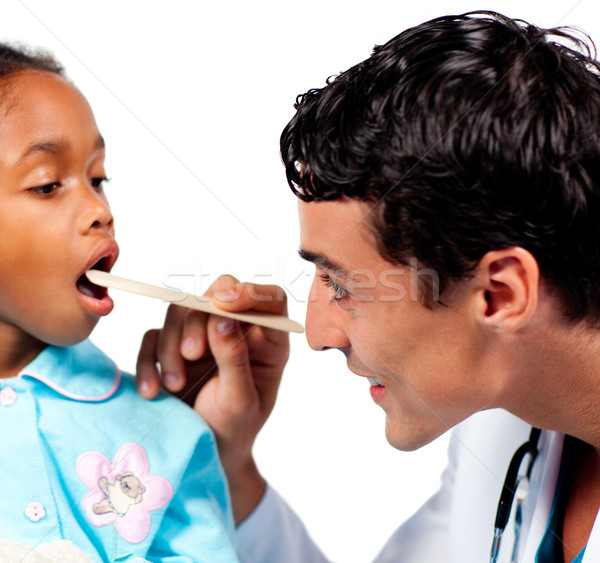 Smiling doctor checking little girl's throat  Stock photo © wavebreak_media