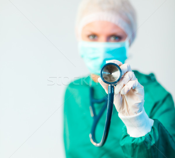 Female Suregon holding stethoscope outwards with focus on the stethoscope Stock photo © wavebreak_media