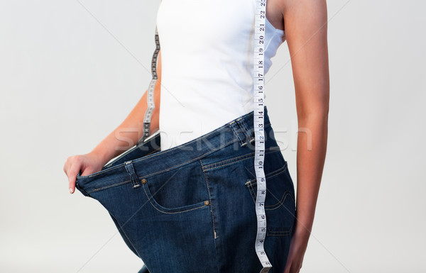 Close-up of woman wearing big jeans  focus on woman  Stock photo © wavebreak_media