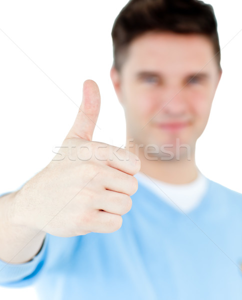 Stock photo: Positive man with thumb up isolated on a white background 
