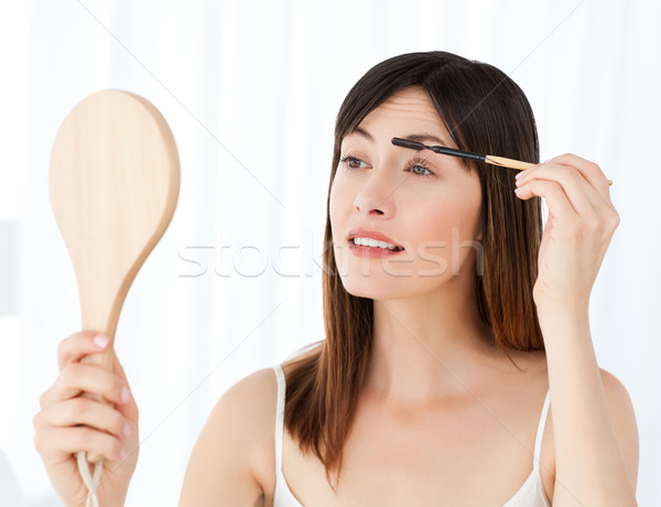 Beautiful woman putting on Make up Stock photo © wavebreak_media