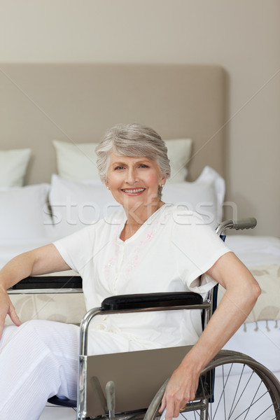 Stock photo: Smiling senior woman in her wheelchair