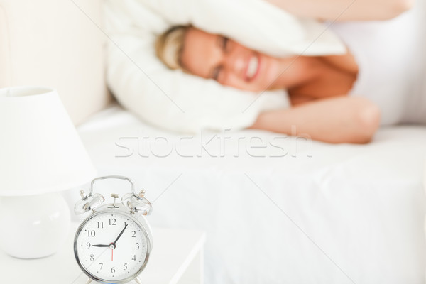 Angry blonde woman waking up in her bedroom Stock photo © wavebreak_media