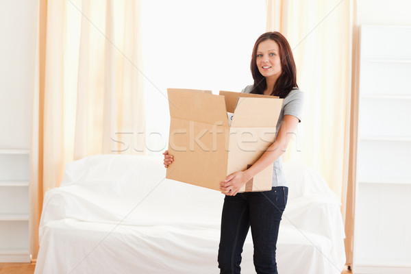 A woman is carrying a cardboard Stock photo © wavebreak_media