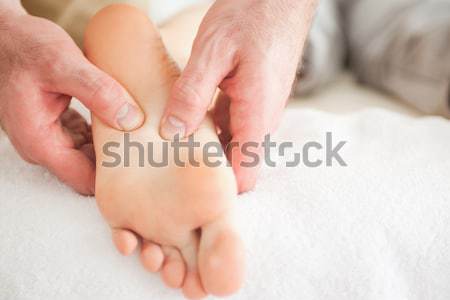 Man massaging a woman's foot in a room Stock photo © wavebreak_media