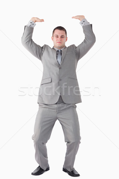 Portrait of a businessman pushing the roof against a white background Stock photo © wavebreak_media