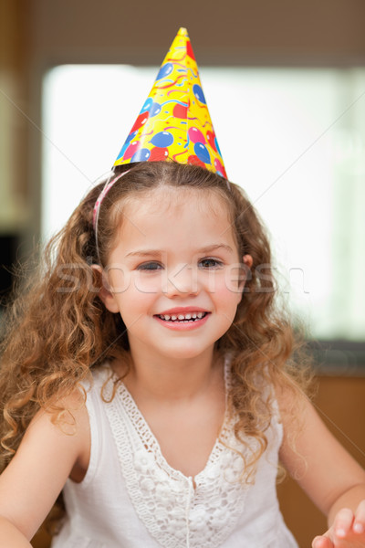 Sonriendo nina fiesta sombrero alimentos casa Foto stock © wavebreak_media