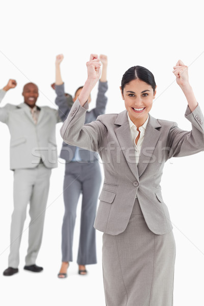 Triumphant saleswoman with cheering associates behind her against a white background Stock photo © wavebreak_media