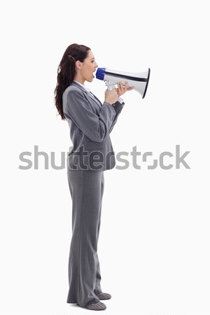 Profile of a businesswoman speaking loudly in a megaphone against white background Stock photo © wavebreak_media