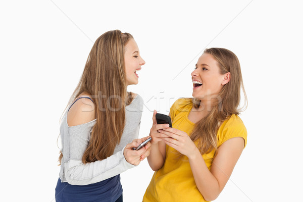 Deux jeunes femmes rire blanche jaune [[stock_photo]] © wavebreak_media