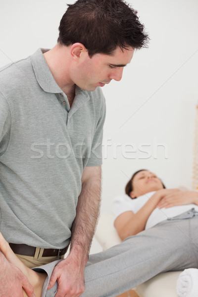 Physiotherapist stretching the leg of a woman in a room Stock photo © wavebreak_media