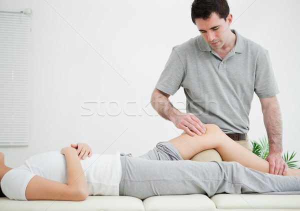 Woman lying on her back while being massaged in a room Stock photo © wavebreak_media
