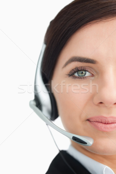 Blue eyed businesswoman with headset against white background Stock photo © wavebreak_media