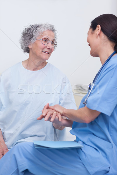 Nurse and a patient sitting on a bed in hospital ward Stock photo © wavebreak_media