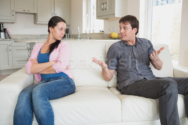 Stock photo: Two young people disputing on the couch in the living room 