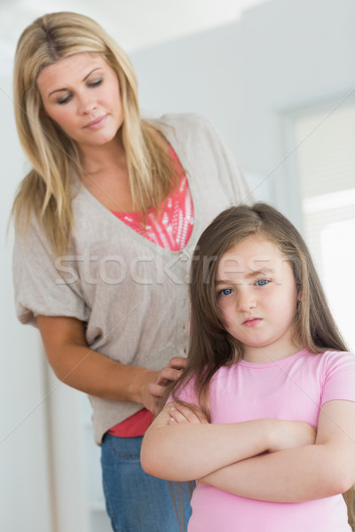 Mother trying comfort angry daughter in kitchen Stock photo © wavebreak_media