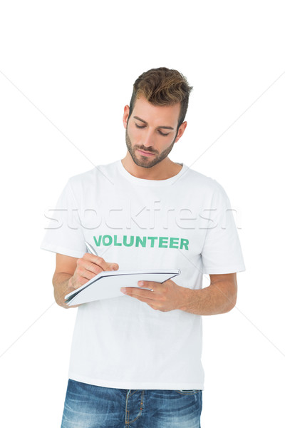 Young male volunteer writing a note Stock photo © wavebreak_media