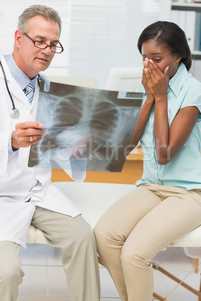 Doctor showing pleased patient her positive chest xray Stock photo © wavebreak_media